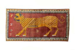 Full view of 2000s Persian Gabbeh rug from Iran / Persia, 213 × 108 cm in Red tones