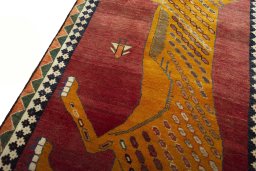 Backside of handmade 2000s Persian Gabbeh rug showing knot structure and weave density
