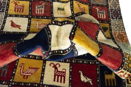 Corner detail of 2000s Persian Gabbeh rug showing border pattern and Wool pile