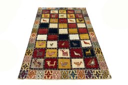 Surface texture of 2000s Persian Gabbeh rug with natural Wool and intricate pattern