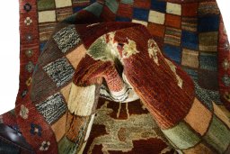Corner detail of 2000s Persian Gabbeh rug showing border pattern and Wool pile