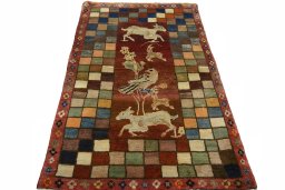 Surface texture of 2000s Persian Gabbeh rug with natural Wool and intricate pattern