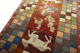 Backside of handmade 2000s Persian Gabbeh rug showing knot structure and weave density