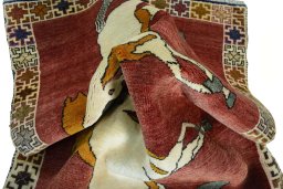 Corner detail of 2000s Persian Gabbeh rug showing border pattern and Wool pile