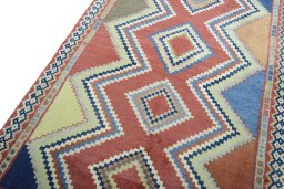 Backside of handmade 2000s Persian Gabbeh rug showing knot structure and weave density