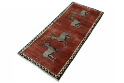 Corner detail of 2000s Persian Gabbeh rug showing border pattern and Wool pile