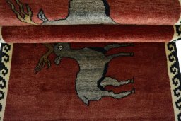 Full view of 2000s Persian Gabbeh rug from Iran / Persia, 171 × 74 cm in Red tones