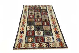 Surface texture of 2000s Persian Gabbeh rug with natural Wool and intricate pattern