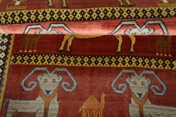 Full view of 2000s Persian Gabbeh rug from Iran / Persia, 190 × 112 cm in Red tones