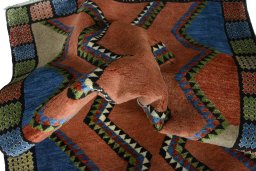 Corner detail of 2000s Persian Gabbeh rug showing border pattern and Wool pile