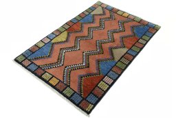 Corner detail of 2000s Persian Gabbeh rug showing border pattern and Wool pile