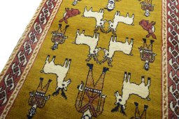 Backside of handmade 2000s Persian Gabbeh rug showing knot structure and weave density