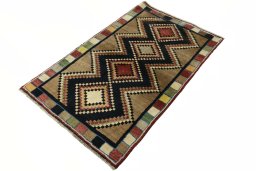 Corner detail of 2000s Persian Gabbeh rug showing border pattern and Wool pile