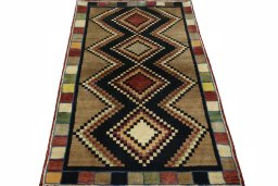 Surface texture of 2000s Persian Gabbeh rug with natural Wool and intricate pattern