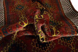 Corner detail of 2000s Persian Gabbeh rug showing border pattern and Wool pile