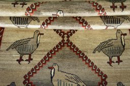Full view of 2000s Persian Gabbeh rug from Iran / Persia, 202 × 117 cm in Beige tones