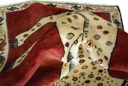 Corner detail of 2000s Persian Gabbeh rug showing border pattern and Wool pile
