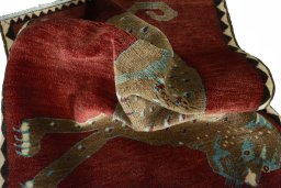 Corner detail of 2000s Persian Gabbeh rug showing border pattern and Wool pile