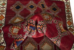 Corner detail of 2000s Persian Gabbeh rug showing border pattern and Wool pile