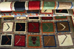 Corner detail of 2000s Persian Gabbeh rug showing border pattern and Wool pile