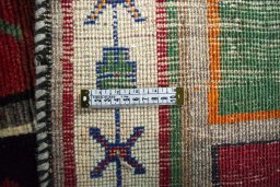 Surface texture of 2000s Persian Gabbeh rug with natural Wool and intricate pattern