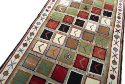 Backside of handmade 2000s Persian Gabbeh rug showing knot structure and weave density