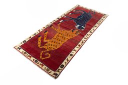 Corner detail of 2000s Persian Gabbeh rug showing border pattern and Wool pile