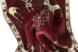 Corner detail of 2000s Persian Gabbeh rug showing border pattern and Wool pile