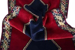 Corner detail of 2000s Persian Gabbeh rug showing border pattern and Wool pile
