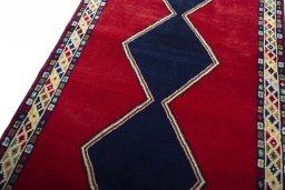 Backside of handmade 2000s Persian Gabbeh rug showing knot structure and weave density