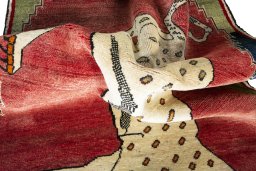 Corner detail of 2000s Persian Gabbeh rug showing border pattern and Wool pile