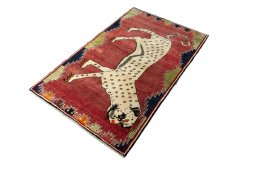 Corner detail of 2000s Persian Gabbeh rug showing border pattern and Wool pile