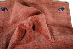 Corner detail of 2000s Persian Gabbeh rug showing border pattern and Wool pile