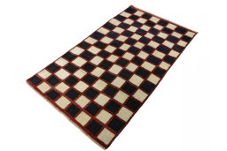 Corner detail of 2000s Persian Gabbeh rug showing border pattern and Wool pile