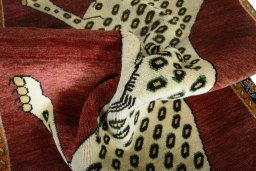 Corner detail of 2000s Persian Gabbeh rug showing border pattern and Wool pile