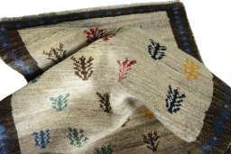 Corner detail of 2000s Persian Gabbeh rug showing border pattern and Wool pile
