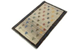 Corner detail of 2000s Persian Gabbeh rug showing border pattern and Wool pile