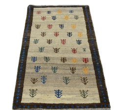 Surface texture of 2000s Persian Gabbeh rug with natural Wool and intricate pattern