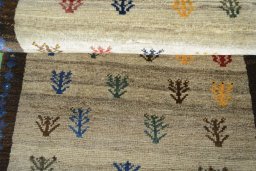 Full view of 2000s Persian Gabbeh rug from Iran / Persia, 135 × 81 cm in Beige tones