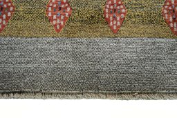 Backside of handmade 2000s Persian Gabbeh rug showing knot structure and weave density