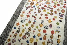 Backside of handmade 2000s Persian Gabbeh rug showing knot structure and weave density