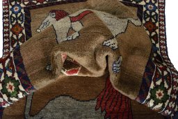 Corner detail of 2000s Persian Gabbeh rug showing border pattern and Wool pile