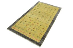 Corner detail of 2000s Persian Gabbeh rug showing border pattern and Wool pile