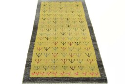 Surface texture of 2000s Persian Gabbeh rug with natural Wool and intricate pattern