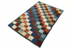 Corner detail of 2000s Persian Gabbeh rug showing border pattern and Wool pile