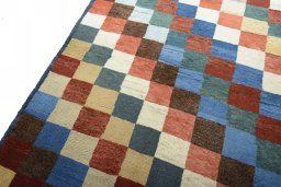 Backside of handmade 2000s Persian Gabbeh rug showing knot structure and weave density
