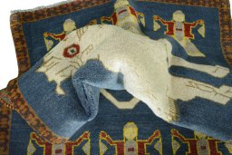 Corner detail of 2000s Persian Gabbeh rug showing border pattern and Wool pile
