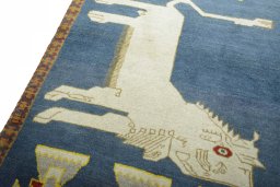 Backside of handmade 2000s Persian Gabbeh rug showing knot structure and weave density