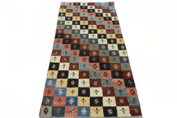 Surface texture of 2000s Persian Gabbeh rug with natural Wool and intricate pattern