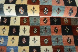 Full view of 2000s Persian Gabbeh rug from Iran / Persia, 181 × 81 cm in Multi Color tones
